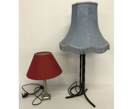 2 modern metal based table lamps complete with shades. A black wrought iron twisted stem lamp with pale blue shade and a brus