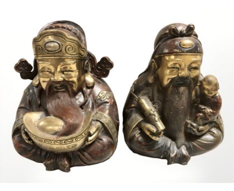 A pair of 20th century Chinese cast and patinated bronze figures of elders, height 23 cm.