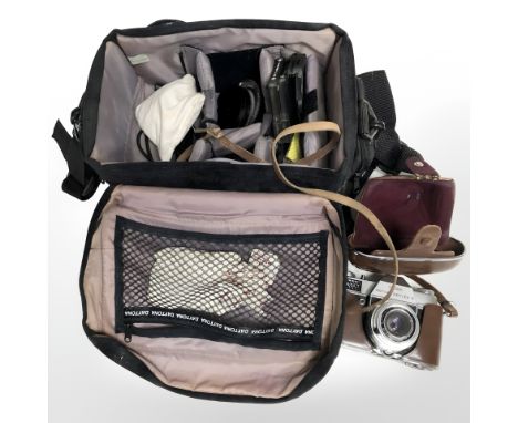 A camera bag containing Kodak Retina Reflex S camera, numbered 80633, and various accessories.