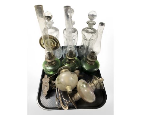 Three early 20th century oil lamps with green glass reservoirs, a further pair of oil lamp wall sconces and three dimple deca