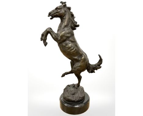 A bronze figure of a rearing horse, on marble socle, height 33.5cm. 