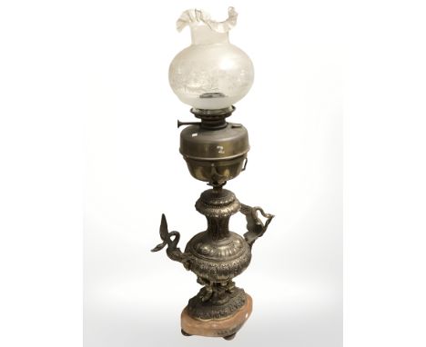 A Victorian brass oil lamp on associated decorative gilt metal twin handled stand, height 90 cm.