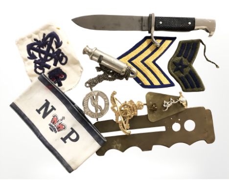 A small quantity of militaria including rank badges, a British Army brass button polisher, a small copy of a German parade ba