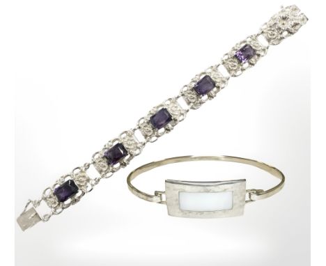 A silver and synthetic amethyst bracelet, length 18cm, and a further silver and mother of pearl bangle. (2)
