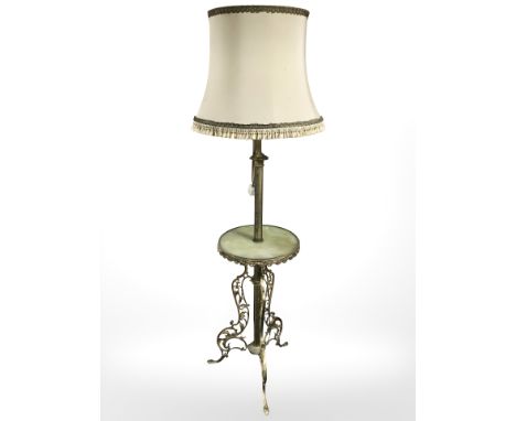 A gilt metal and onyx standing lamp incorporating a table.