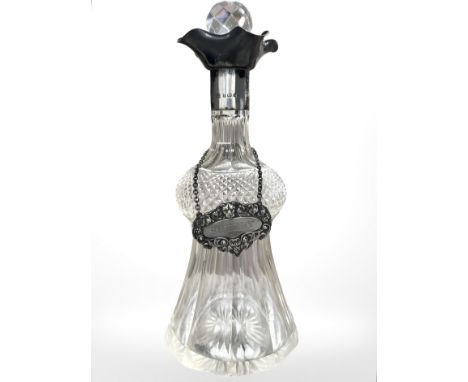 An Edward VII silver-mounted decanter, London 1908, height 26cm, and a silver sherry label. 