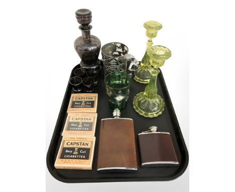 A pair of uranium glass candlesticks, height 20 cm, two reproduction hip flasks, three packs of Capstan Navy Cut cigarettes, 