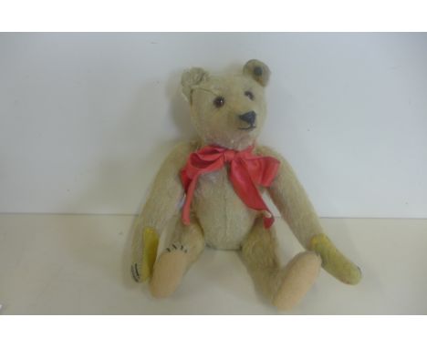 A Steiff bear, 25cm tall, button in ear, issued 1905-1950 - this bear is probably 1920's, glass eyes, extensive mohair loss, 