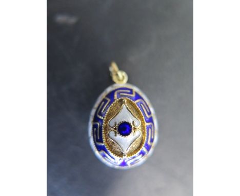 A 14ct gold and enamel Easter egg fob with blue and white enamel, stamped 585 to back, egg surface tested as 14ct, weight app