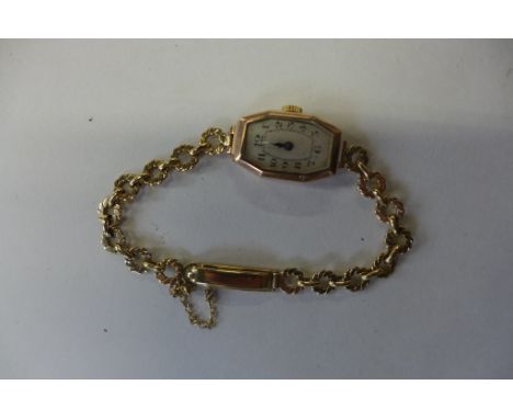 A 9ct yellow manual wind ladies wristwatch 14mm wide, weight of case and strap approx 9.2 grams, running order 
