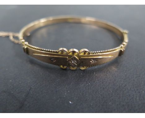 A Victorian style 9ct rose gold diamond set hinged bangle with three small diamonds, weight approx 6.6 grams, diameter 6.3cm,