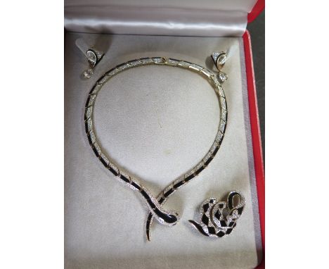 A cased suite of Attwood and Sawyer costume snake themed jewellery with black enamel and crystal/white stones on gilded base 