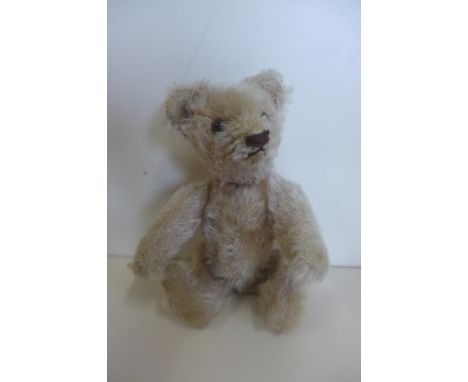 A miniature mohair bear circa 1920'30's, 15cm tall, no button but hole to left ear, probably Steiff, minor wear 