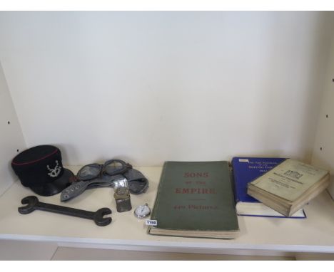 A collection of Militaria to include a flying helmet and goggles, spanner, stopwatch, three books and a Singers tourniquet 