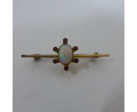 A 9ct yellow gold opal, garnet and ruby brooch, 4cm long, approx 1.8 grams 