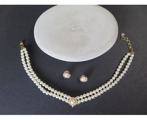 Christian Dior Perles - pearls - A boxed double string of Dior imitation pearls with gold plated and white stone centre, neck