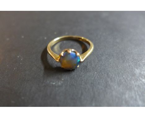 A 9ct rose gold ring, set with a circular opal - ring size N, weight approx 1.7 grams - usage marks to ring, small chip to ed