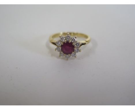 A good 18ct hallmarked ruby and diamond cluster ring, head approx 10mm wide, ring size J - approx 3.2 grams - in good conditi