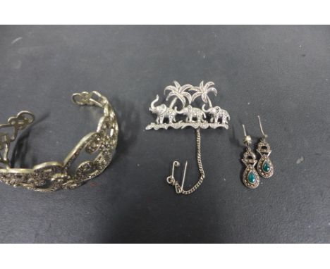 A good quality silver and marcasite elephant brooch stamped sterling and a silver and marcasite open bangle and pair of earri