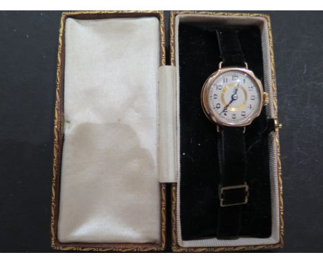 A ladies 9ct light rose gold Art Deco style wristwatch, white enamel face with Arabic numerals, dial marked with a monogram w