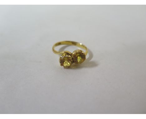A 22ct and yellow sapphire crossover ring, marked 22K, ring size S, approx 4.9 grams, in a generally good condition 