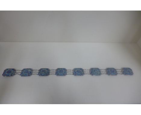 A Chinese white metal and enamel belt, 66cm long, approx 6 troy oz, some enamel losses but reasonably good 