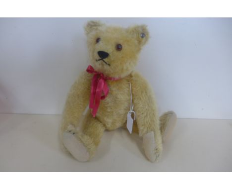 A Steiff bear, late 1930's - 30cm tall, golden mohair with felt pads, button in ear, non working squeaker, good condition 