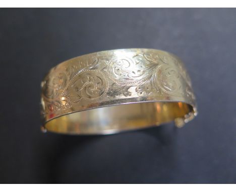 A 9ct rolled gold Victorian style hinged bangle, marked 1/5 9ct rolled gold, weight approx 52.5 grams 