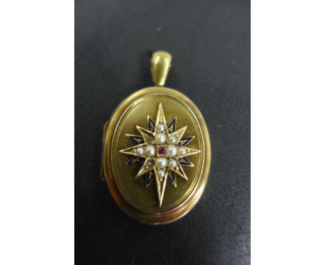 A Victorian gold mourning locket, the front set with a ruby and seed pearls in a star shape with blue enamel inside a painted