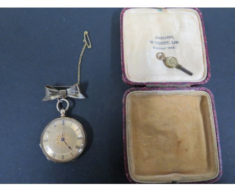 An 18ct gold enameled ladies fob watch with decorated and gilded face and Roman numerals, weight approx 37.5 grams, back of c