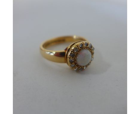 A hallmarked 18ct yellow gold opal and diamond ring, size S, approx 7.9 grams, in good condition 