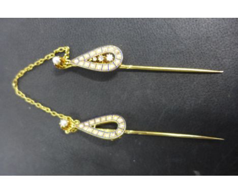 A gold, diamond and seed pearl double scarf pin, the twin tear shape pendants set with seed pearls and framed by blue enamel,