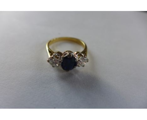 An 18ct yellow gold and platinum sapphire and diamond ring, each diamond approx 0.25ct, central sapphire approx 7x6x3mm, ring