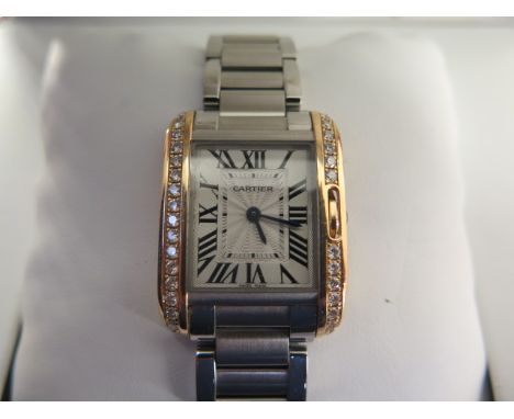 A ladies Cartier steel rose gold and diamond tank wristwatch, rectangular case, silvered face with engine turned decoration, 