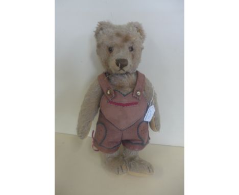 A Steiff bear, circa 1952-70 - 32cm tall, button in ear with remains of yellow tag, pads good condition, non working squeaker