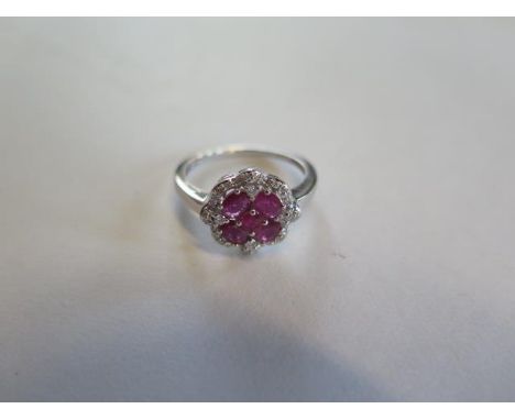 A 14ct white gold four stone ruby and diamond ring, size N, approx 2.9 grams, in good condition 