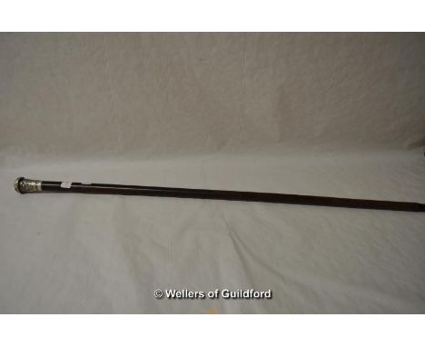 A malacca walking cane, the white metal finial decorated with a three toed dragon, stamped 'PC 90', 89cm overall.