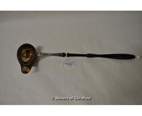 A white metal punch ladle, the turned wooden handle with ivory knop, the bowl stamped 830, 39cm.