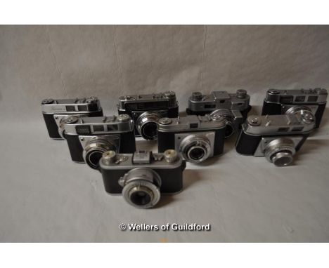 Eight Kodak cameras with lenses. Camera bodies include - Retinette (x2), 35 (x2), Retinette IA, Retinette IB, RetinetteIIa an