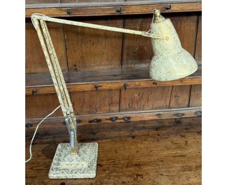 A cream and gold painted anglepoise lamp