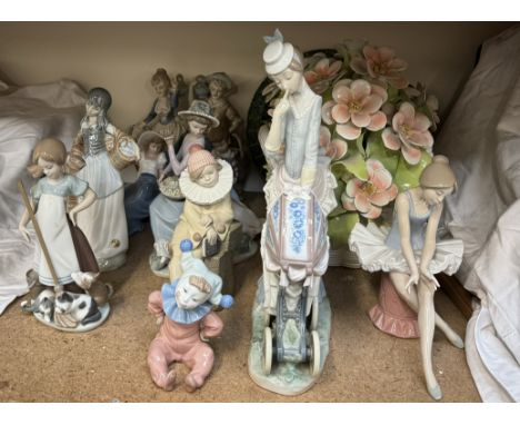 A large Lladro figure group of a lady pushing a pram together with Lladro, Nao and other figures a large floral centrepiece e