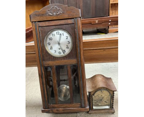 An oak cased wall clock together with an oak cased mantle clock