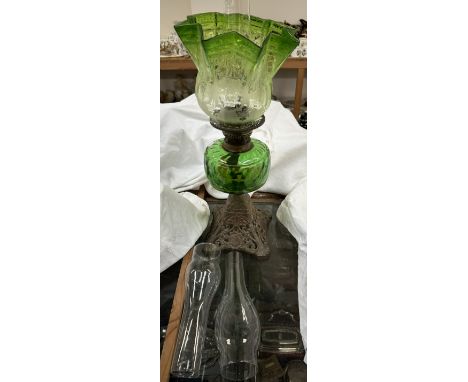 A Victorian green glass oil lamp, with a graded glass shade and a metal base 
