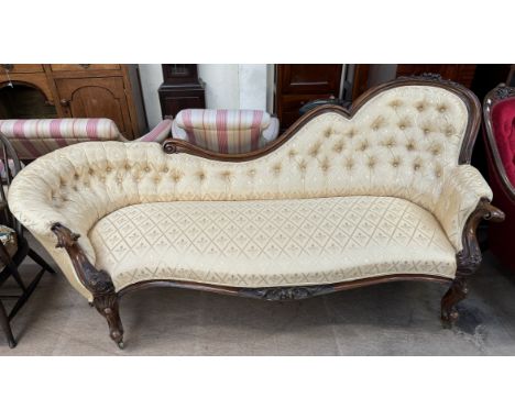 A Victorian walnut framed chair back settee carved with fruit and flowers with chequered yellow button back upholstery and a 