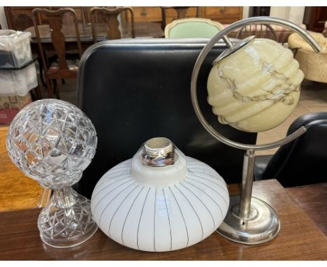 An Art Deco design glass lamp shade of spherical form on a stainless steel base together with another opaque glass ceiling sh