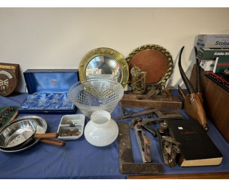 A brass circular mirror together with a brass tray, carved antelope head, woodworking tools, large glass bowl, glass tumblers