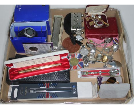 A box of assorted items including a Parker 61 rolled gold fountain pen and other pens, watches including Casio, Swarovski and