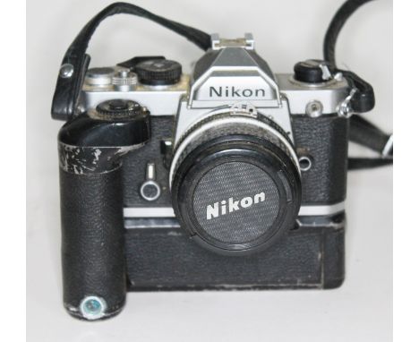 A Nikon FM SLR camera serial no. 2605179 with NIkkor50mm 1"1.8 lens serial no. 2071425 and Nikon MD-12.  Condition - as found