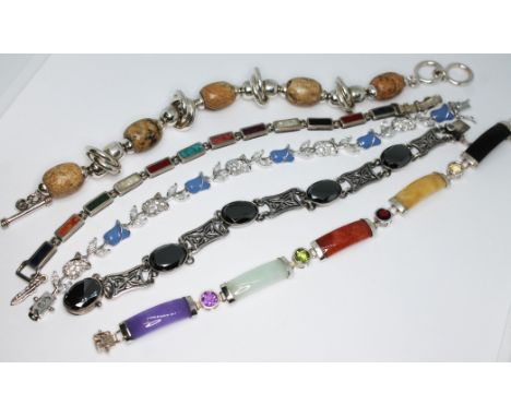 A group of five bracelets marked '925' including one formed from concave slabs of coloured jade interspersed with round cut c