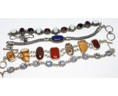 A group of cabochon bracelets set with various stones including moonstone, lapis lazuli, mother of pearl etc. lengths 18cm to
